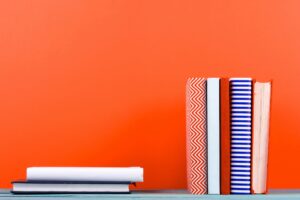 Books on orange background